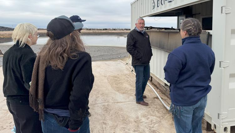 Event participants viewing vermifiltration system.