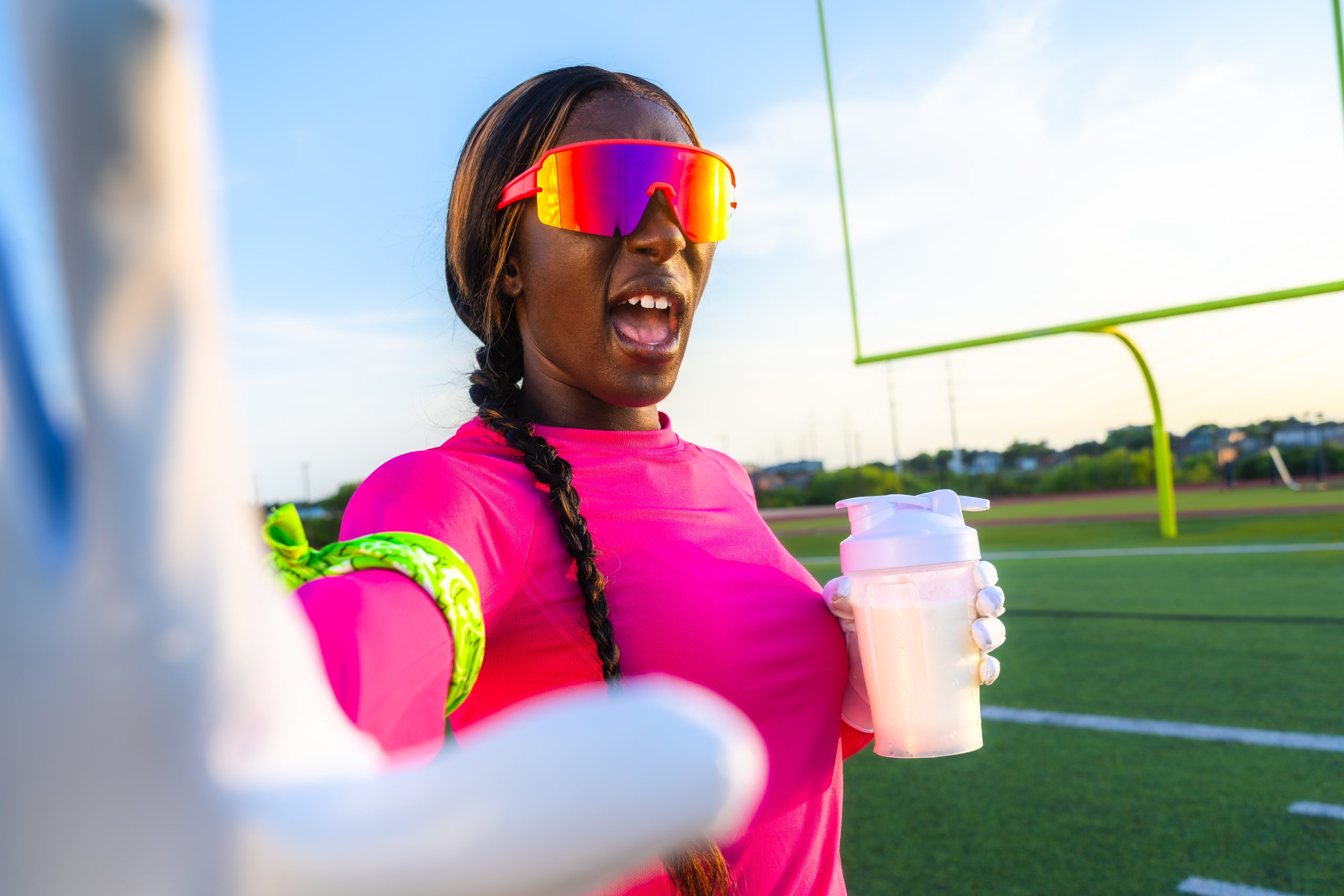 Female football player with glass of milk